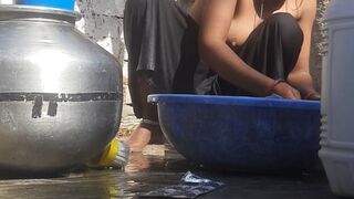 Indian stepsister is preparing to take a bath while washing clothes in the open courtyard of the house